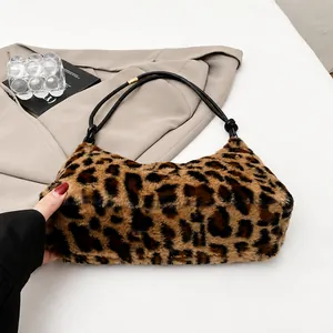Close-up of leopard print faux fur crescent bag showing soft texture and gold buckle detail