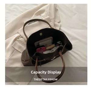 Spacious interior of dark brown suede tote bag showing storage for daily essentials