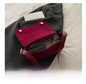 Interior view of the burgundy shoulder bag showing space for cosmetics and essentials