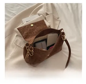 Interior view showing the large capacity and magnetic closure of the leopard shoulder bag