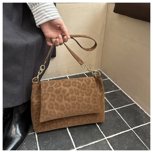 Detail of leopard print shoulder bag with gold chain strap and suede texture finish