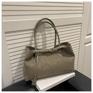 Detail of taupe leopard print tote bag with gold buckle and suede texture