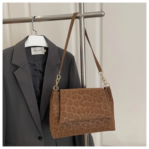 Detail view of leopard print shoulder bag with gold chain and soft suede texture