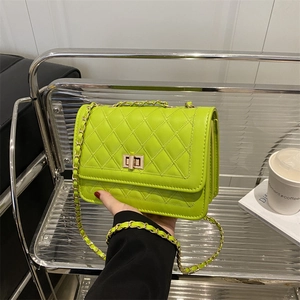 Fluorescent green quilted crossbody bag with gold turn-lock and chain strap detail