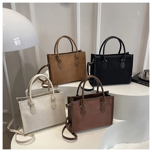 Detailed macro view of four minimalist tote bags with embossed clover patterns in neutral tones