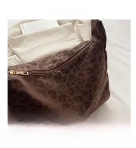 Close-up of leopard print tote bag featuring a high-quality gold zipper and texture