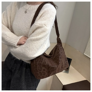 Detailed view of the large leopard print tote bag with soft suede texture and wide strap
