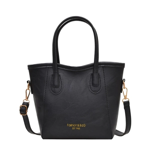 Classic black leather handbag with gold ring handles and adjustable strap for work