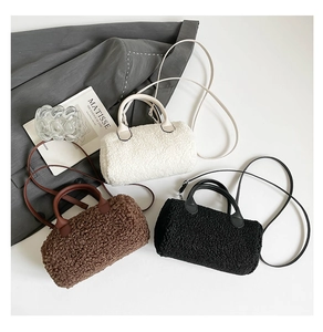Three plush sherpa barrel bags in white, brown, and black with leather handles