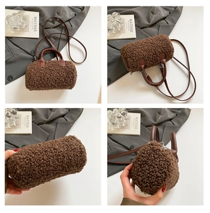 Detail of brown faux shearling cylinder bag with leather handles and silver hardware