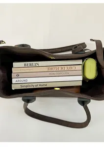 Spacious interior of dark brown leather tote bag showing large capacity and magnetic closure