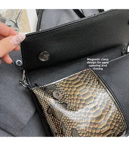 Detail of snake print handbag featuring a secure magnetic snap closure design