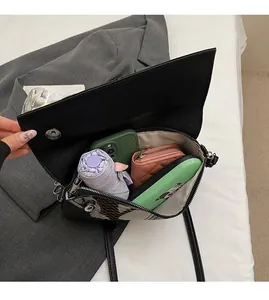 Top view of black faux leather flap bag interior showing ample storage space for essentials