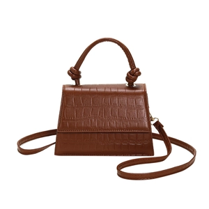 Brown crocodile embossed faux leather handbag with a knotted handle and adjustable strap
