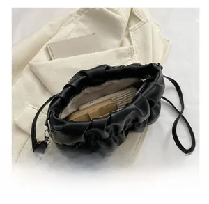 Close-up of black pleated cloud bag interior showing spacious capacity for phone and wallet
