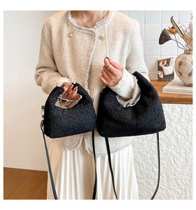 Close-up of black fuzzy fleece crescent bag set showing soft texture and metal hooks