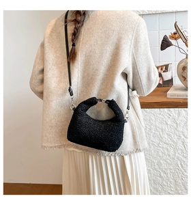 Close-up of black fuzzy moon bag texture and silver metal hardware details