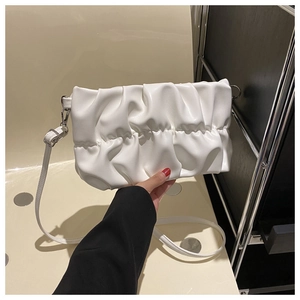 Detail view of white pleated PU leather handbag featuring a silver metal buckle and strap