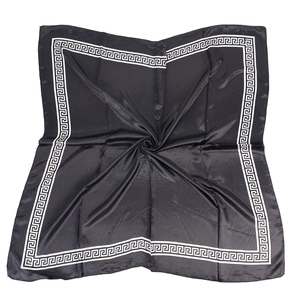 Detail of satin square scarf featuring black fabric with white Greek meander border pattern