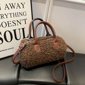 Brown faux lamb wool cylindrical handbag with leather straps in a cozy lifestyle setting
