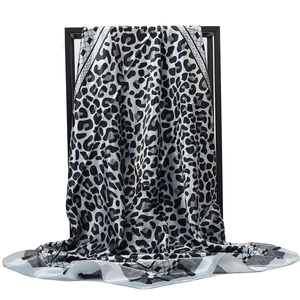 Macro detail of the leopard print satin silk scarf with black geometric border design