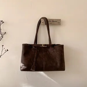 Large dark brown faux suede tote bag with minimalist gold buckle and long shoulder straps