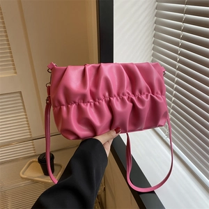 Pink pleated dumpling underarm bag with a slender leather strap and elegant texture