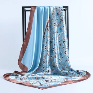 Elegant floral print satin scarf in light blue and brown with a smooth silk-like finish