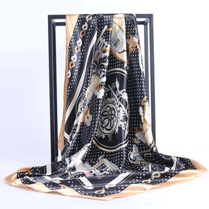 Detail of silk-satin square scarf featuring black and gold horse carriage patterns