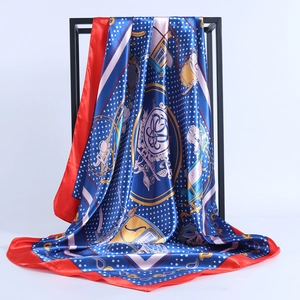 Navy blue satin square scarf with vintage carriage print and red border on metal stand