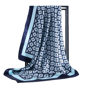 Elegant floral print satin silk square scarf draped on a black stand in 90x90cm size