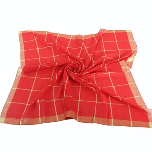 Detailed view of red and gold checkered cotton scarf with silk thread accents