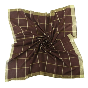 Close-up of brown square scarf featuring golden metallic grid pattern and silky texture