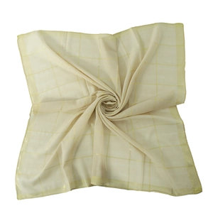Detail of light yellow sheer cotton scarf with golden metallic grid thread patterns