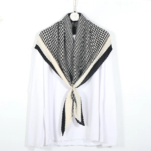 Classic black and white houndstooth pleated scarf on a white long-sleeve shirt