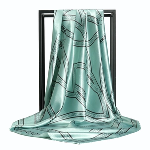 Elegant 90cm mint green silk scarf with black chain patterns on a minimalist metal rack
