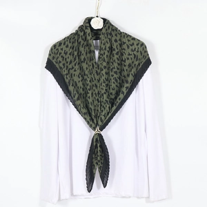 Leopard print pleated cotton linen scarf in olive green and black, styled as a shawl