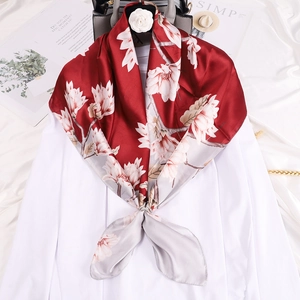 Silk scarf with white magnolia floral print in red and grey on a white shirt