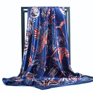Elegant navy blue satin scarf with red paisley and bird prints on a black metal frame