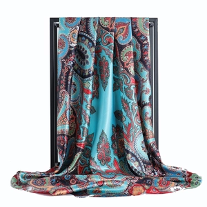 Lake blue 90cm satin scarf with paisley print displayed on a black metal frame