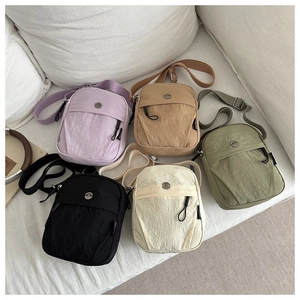 Detailed display of lightweight nylon crossbody bags in five colors with adjustable straps