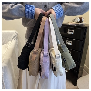 Detail of adjustable textile straps and silver metal buckles on colorful crossbody bags