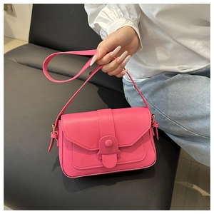 Detail view of pink PU leather handbag showing the unique flap design and gold hardware