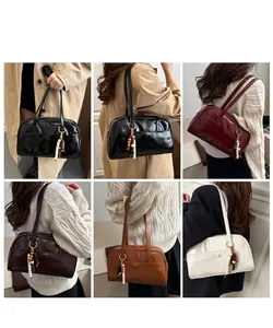 Detailed views of vintage faux leather shoulder bags with a unique beaded charm accessory