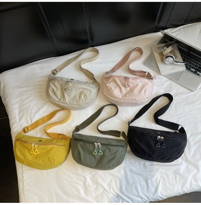 Flat lay of colorful nylon dumpling bags with adjustable straps and zip closure