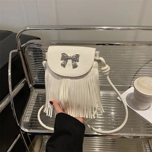 White shoulder bag for women with elegant tassel fringe and silver metal bow decoration