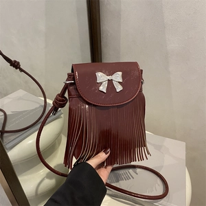 Burgundy patent leather crossbody phone bag with fringe tassel and silver bow detail