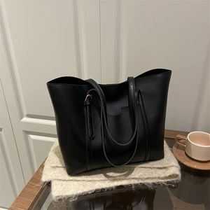 Sac fourre-tout noir minimaliste avec poche frontale sur une écharpe en maille