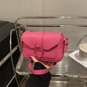 Vibrant rose pink crossbody bag with a minimalist flap design and gold hardware