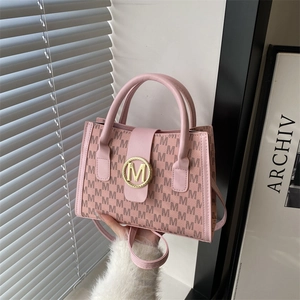 Pink underarm bag with M-letter print and golden buckle from a front view angle